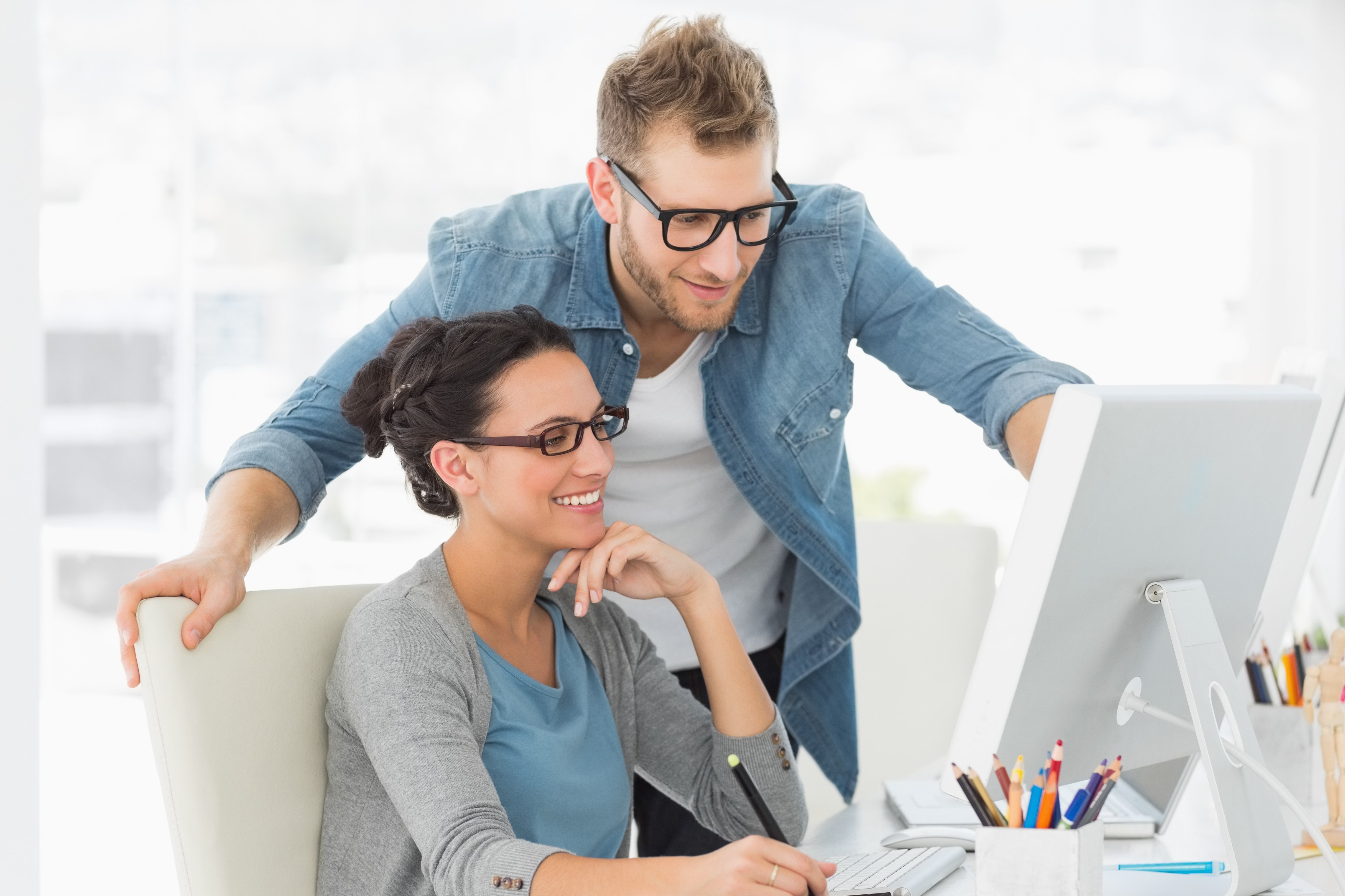 Young design team working at desk in creative office